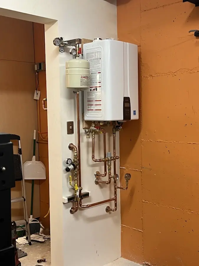 Plumbing technician inspecting water heater connections in South San Jose Hills